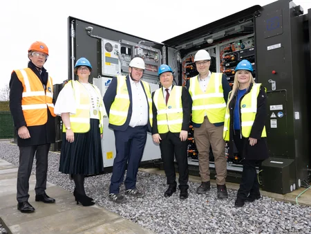 James Cafferty, ESB European Commissioner, and staff members standing in front of battery solution unit on BESS 2 launch day.