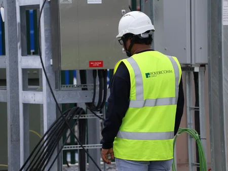 Engineer on site in PPE gear overseeing a transformer lift