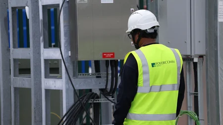 Engineer on site in PPE gear overseeing a transformer lift